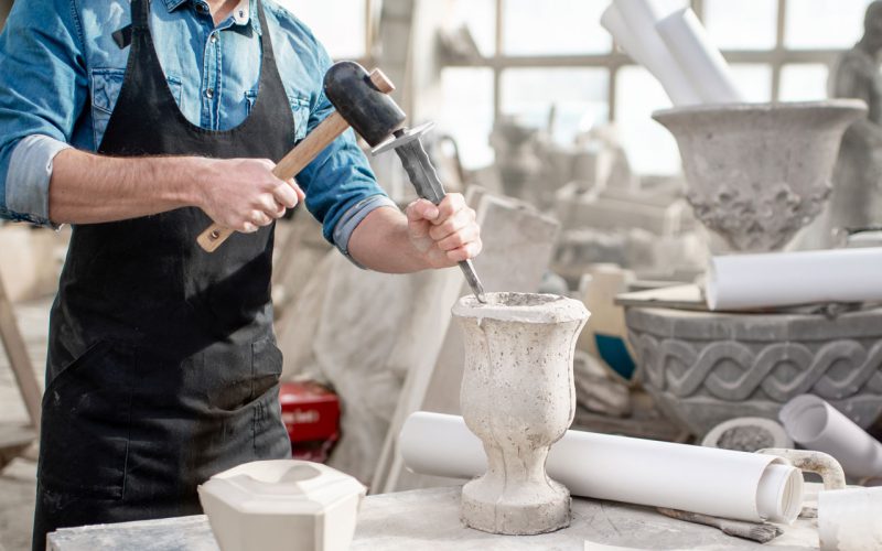 sculptor working with stone vases