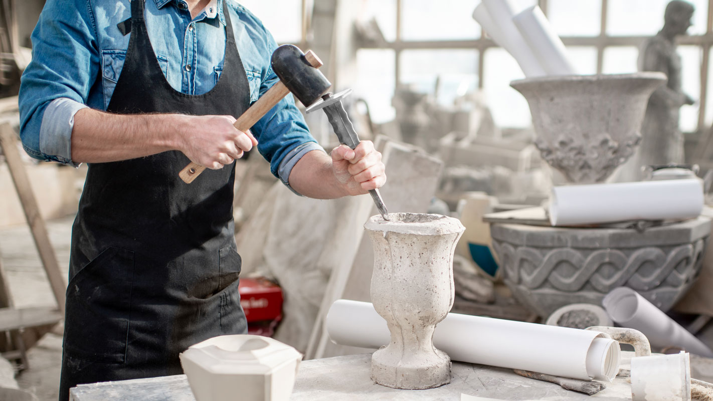 sculptor working with stone vases